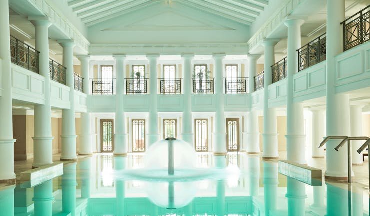 Grecotel Mandola Rosa Greece indoor pool roman style white building fountain