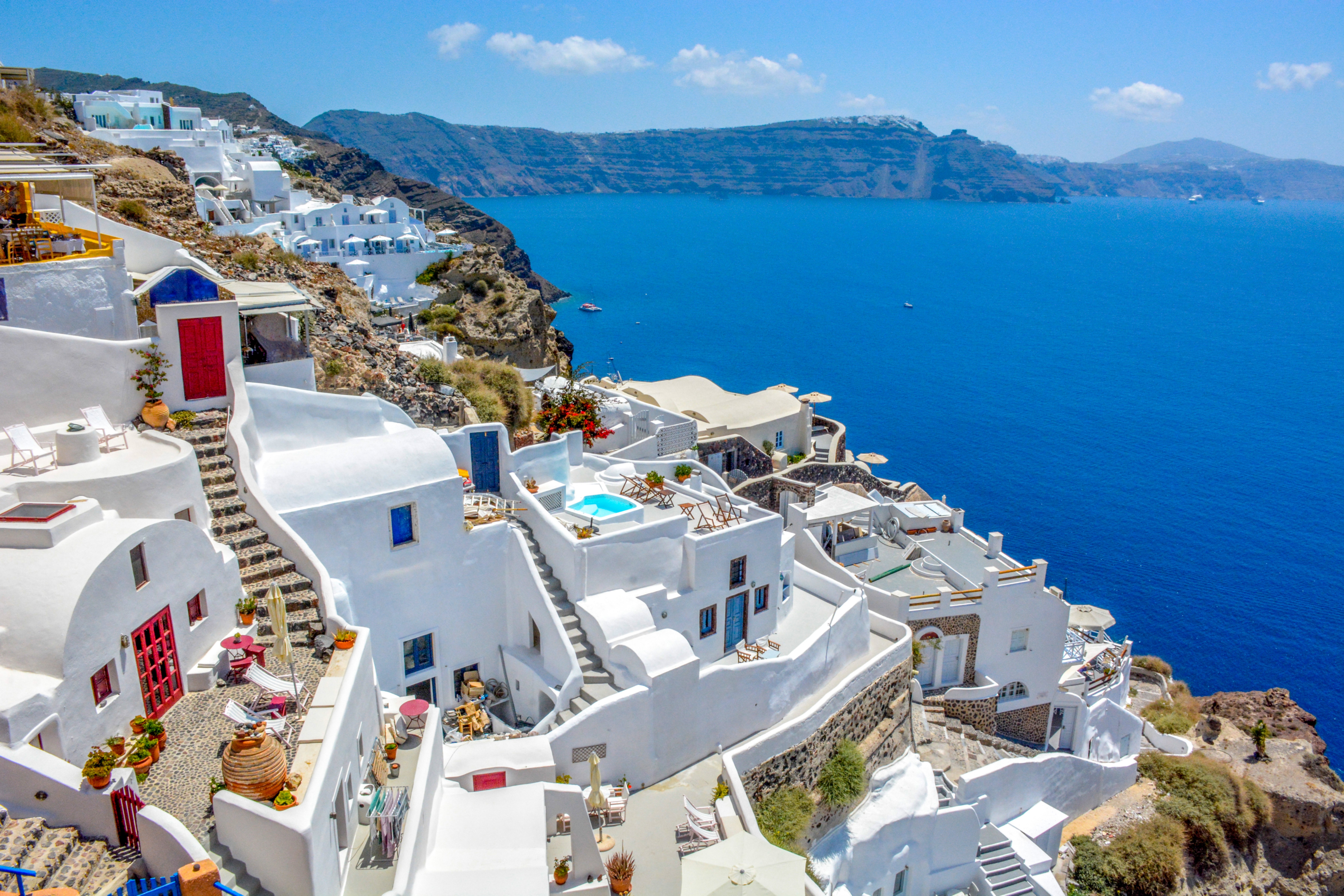 Shot Santorini's famous white buildings, sea and coastline in background