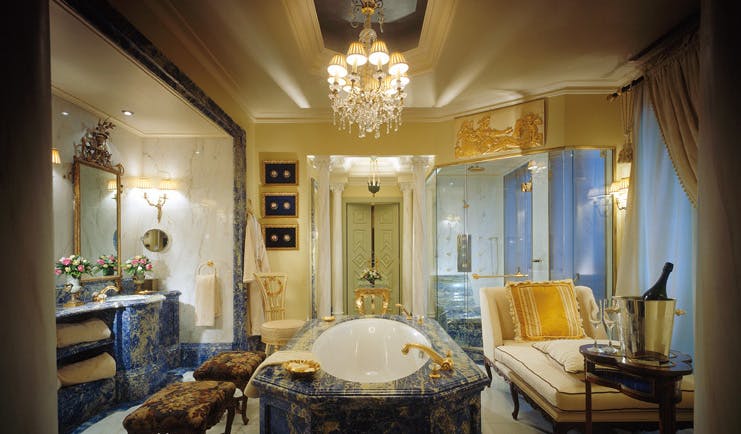 Hotel Grande Bretagne Greece bathroom opulent decor chandelier marble free standing bath chaise longue vanity unit