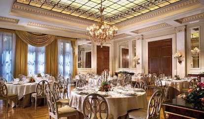 Hotel Grande Bretagne Greece dining room opulent decor chandeliers glass roof 