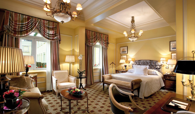 Hotel Grande Bretagne Greece large bedroom opulent decor chandelier sofa and chairs