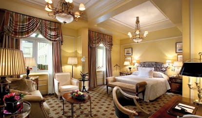 Hotel Grande Bretagne Greece large bedroom opulent decor chandelier sofa and chairs