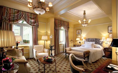 Hotel Grande Bretagne Greece large bedroom opulent decor chandelier sofa and chairs