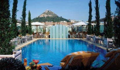Hotel Grande Bretagne Greece outdoor pool sun lounger umbrellas mountain view