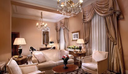 Hotel Grande Bretagne Greece sitting room opulent traditional decor chandeliers draped curtains