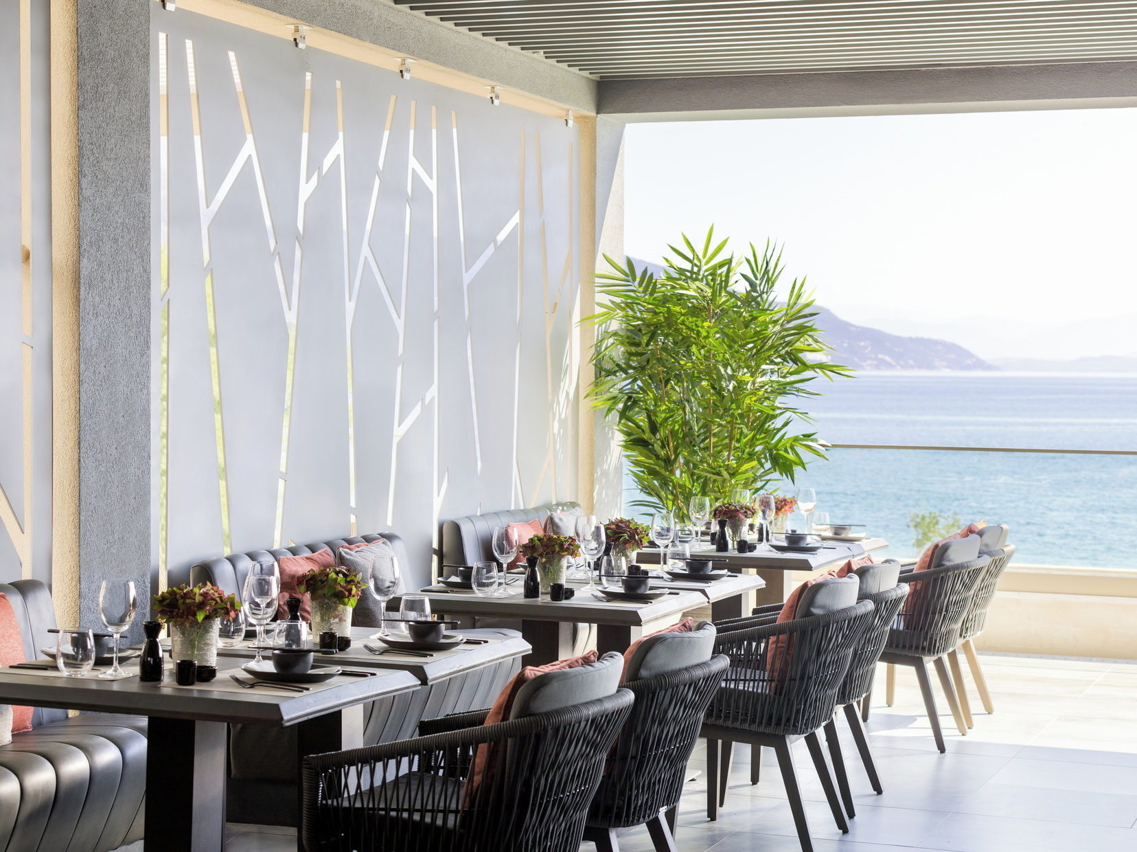 Ikos Dassia Greece Anaya restaurant dining area with leather benches and sea view