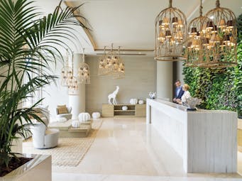 Ikos Dassia Greece lobby with vegetal wall and wooden chandeliers