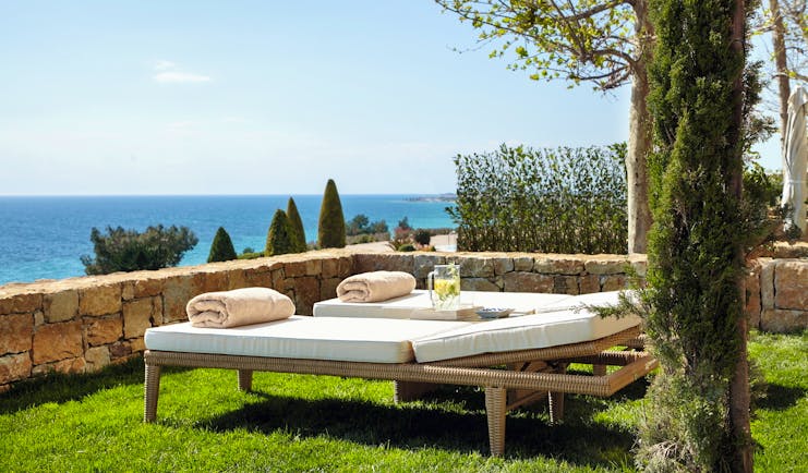 Ikos Oceania Greece private garden with two sun loungers and sea view