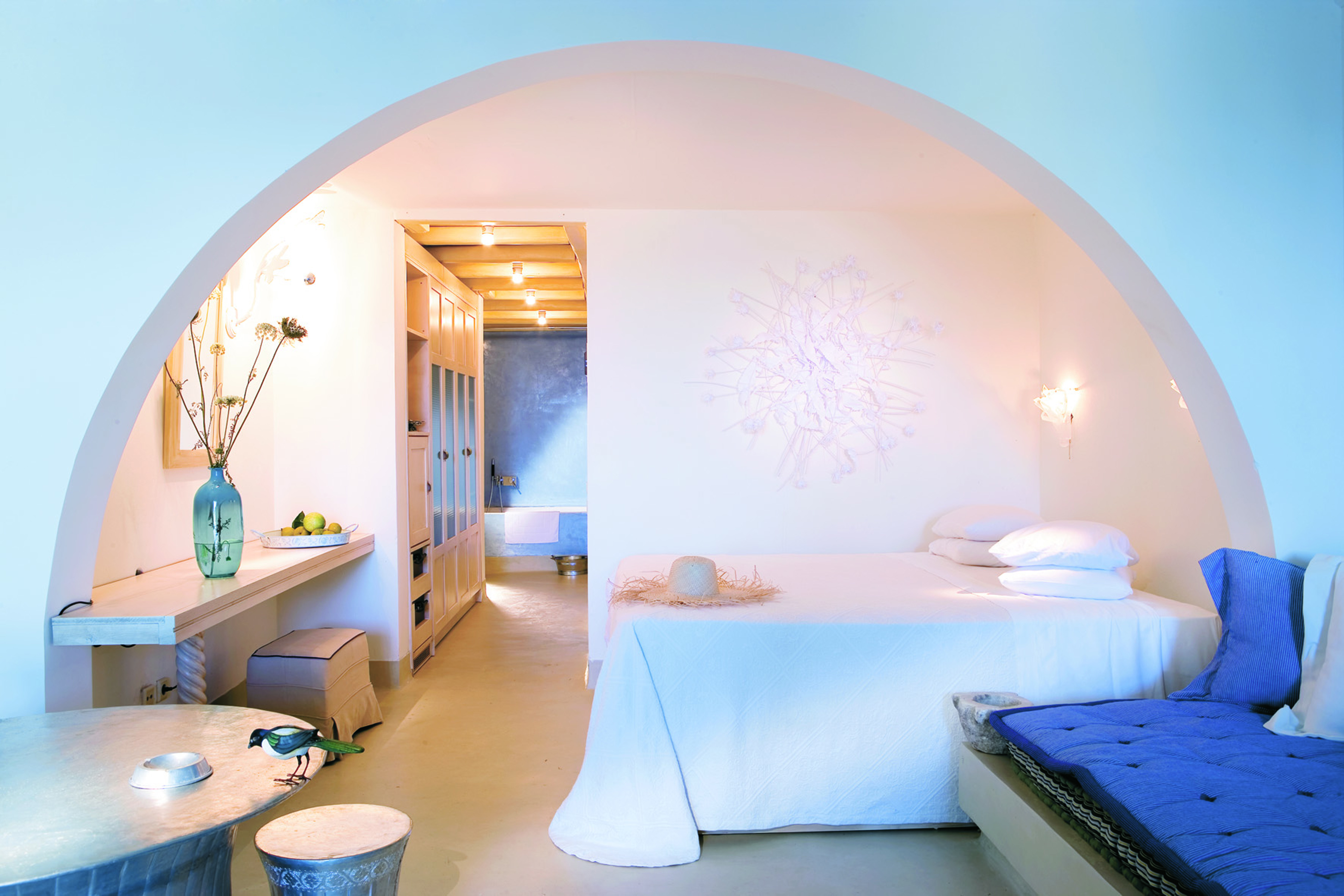 Mykonos Blu Greece Grecotel bungalow bedroom suite with white archway seating area