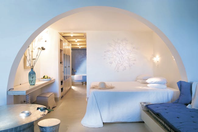 Mykonos Blu Greece Grecotel bungalow bedroom suite with white archway seating area