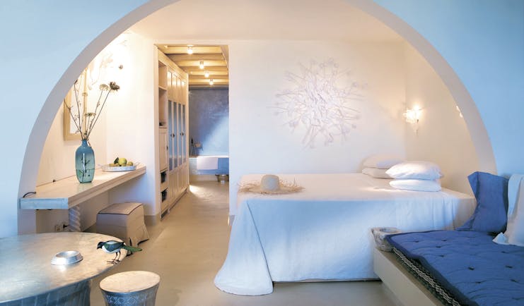 Mykonos Blu Greece Grecotel bungalow bedroom suite with white archway seating area