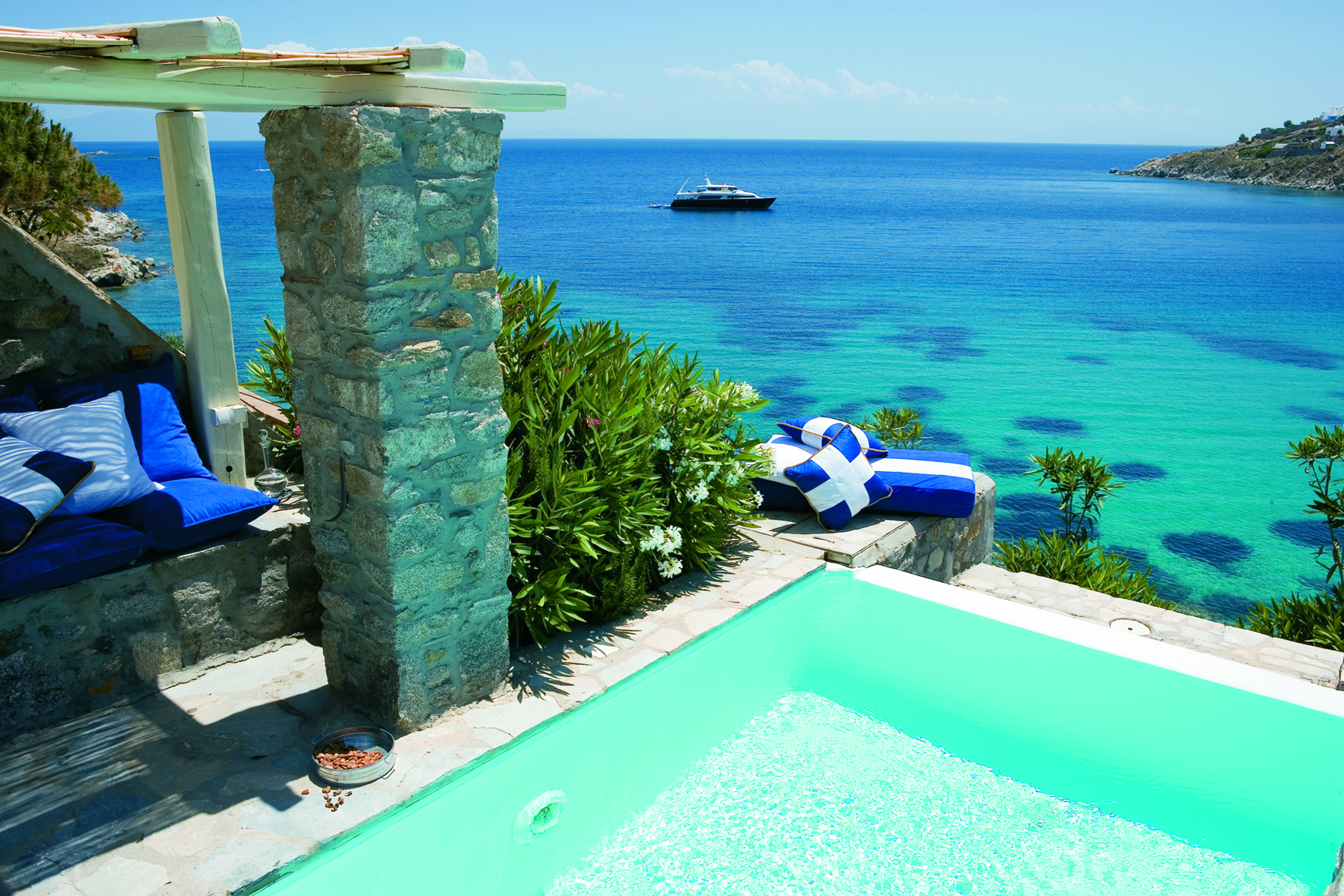 Mykonos Blu Greece Grecotel private pool with stone walls and beach view