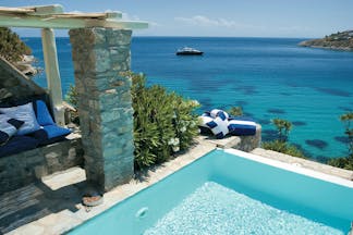 Mykonos Blu Greece Grecotel private pool with stone walls and beach view