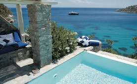 Mykonos Blu Greece Grecotel private pool with stone walls and beach view