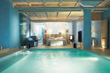 Mykonos Blu Greece Grecotel villa bedroom pool suite with blue walls and wooden roof