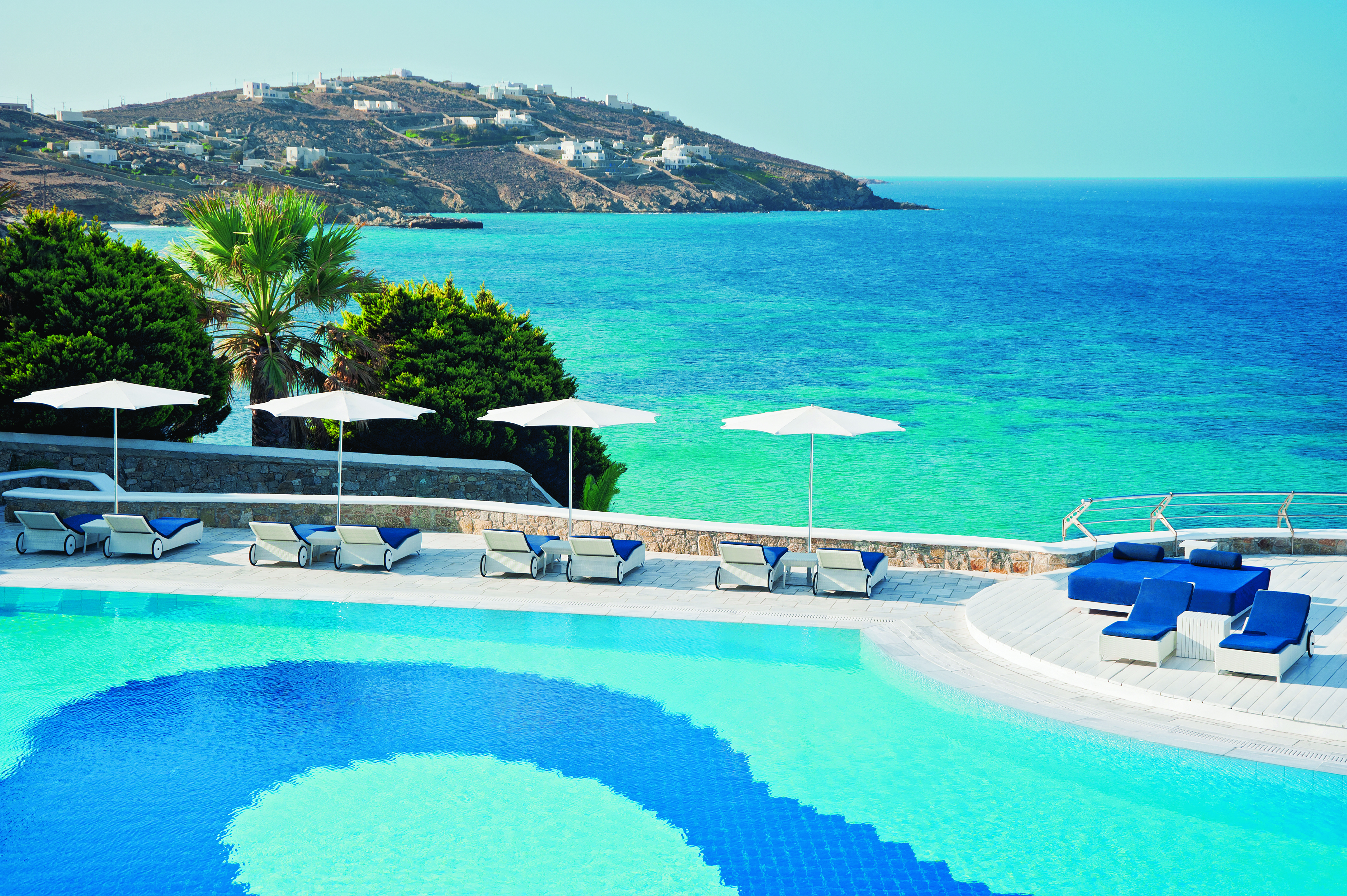 Mykonos Grand Hotel Greece exterior pool with sun loungers looking over the sea
