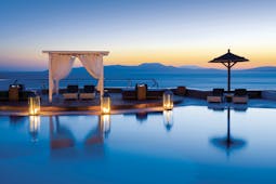 Mykonos Grand Hotel Greece main pool with decked area and cabana at night