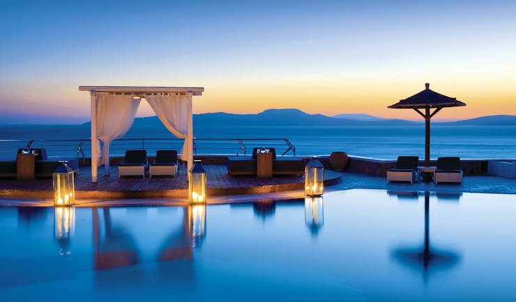 Mykonos Grand Hotel Greece main pool with decked area and cabana at night