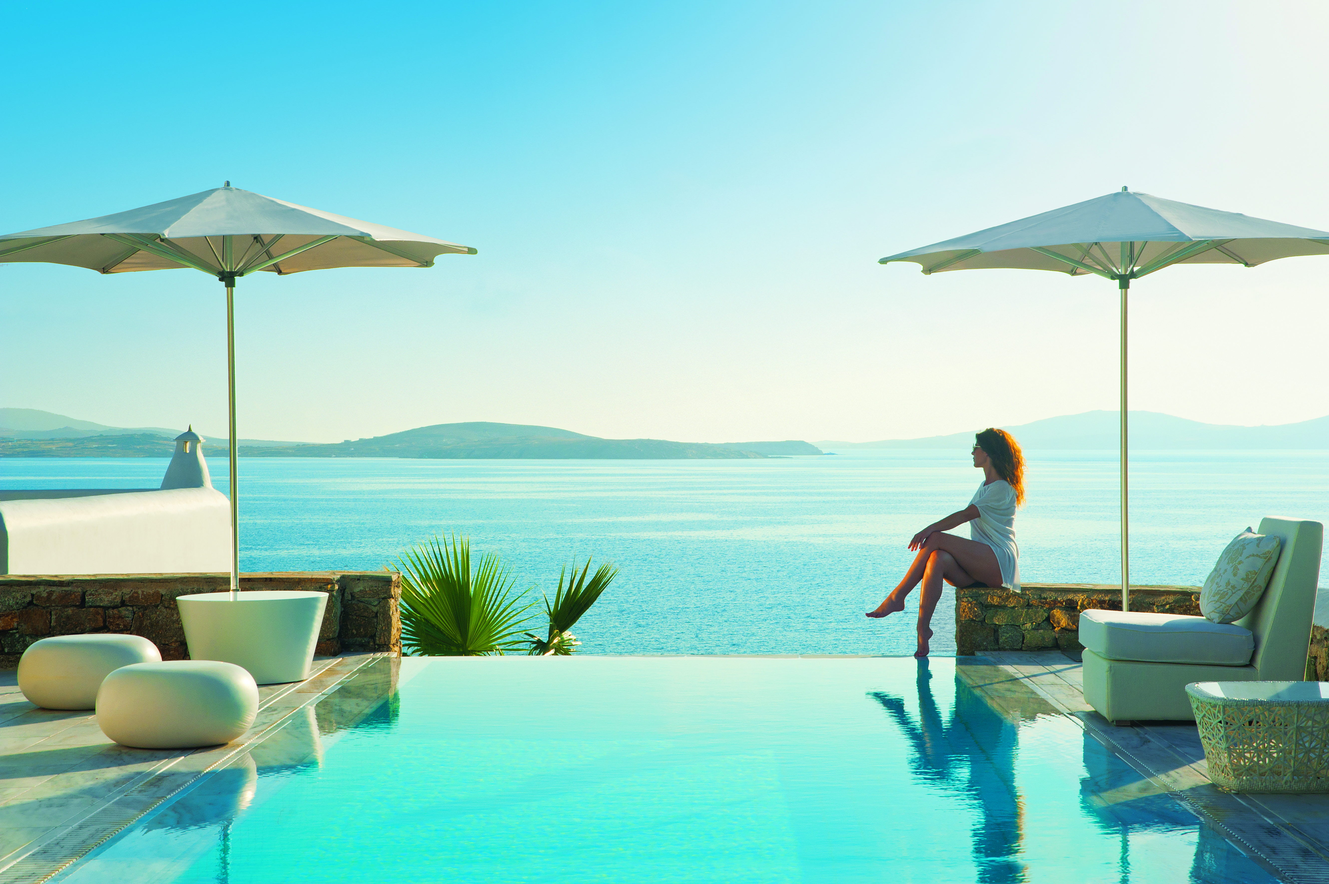 Mykonos Grand Hotel Greece pool sea outdoor woman sitting at private pool with sea view