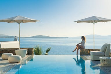 Mykonos Grand Hotel Greece pool sea outdoor woman sitting at private pool with sea view