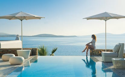 Mykonos Grand Hotel Greece pool sea outdoor woman sitting at private pool with sea view