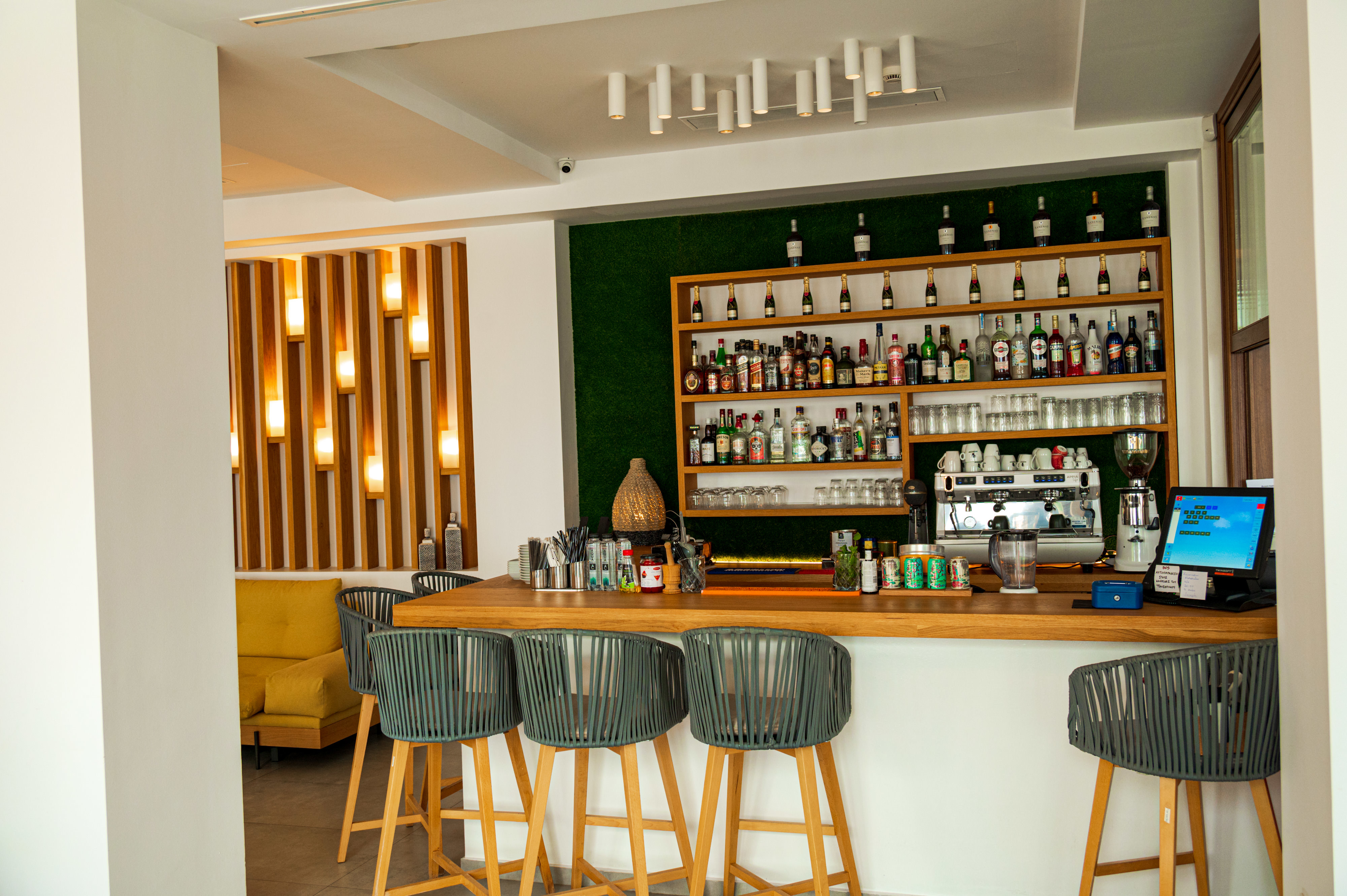 Natura Luxury Boutique Hotel bar with wood and teal colour scheme