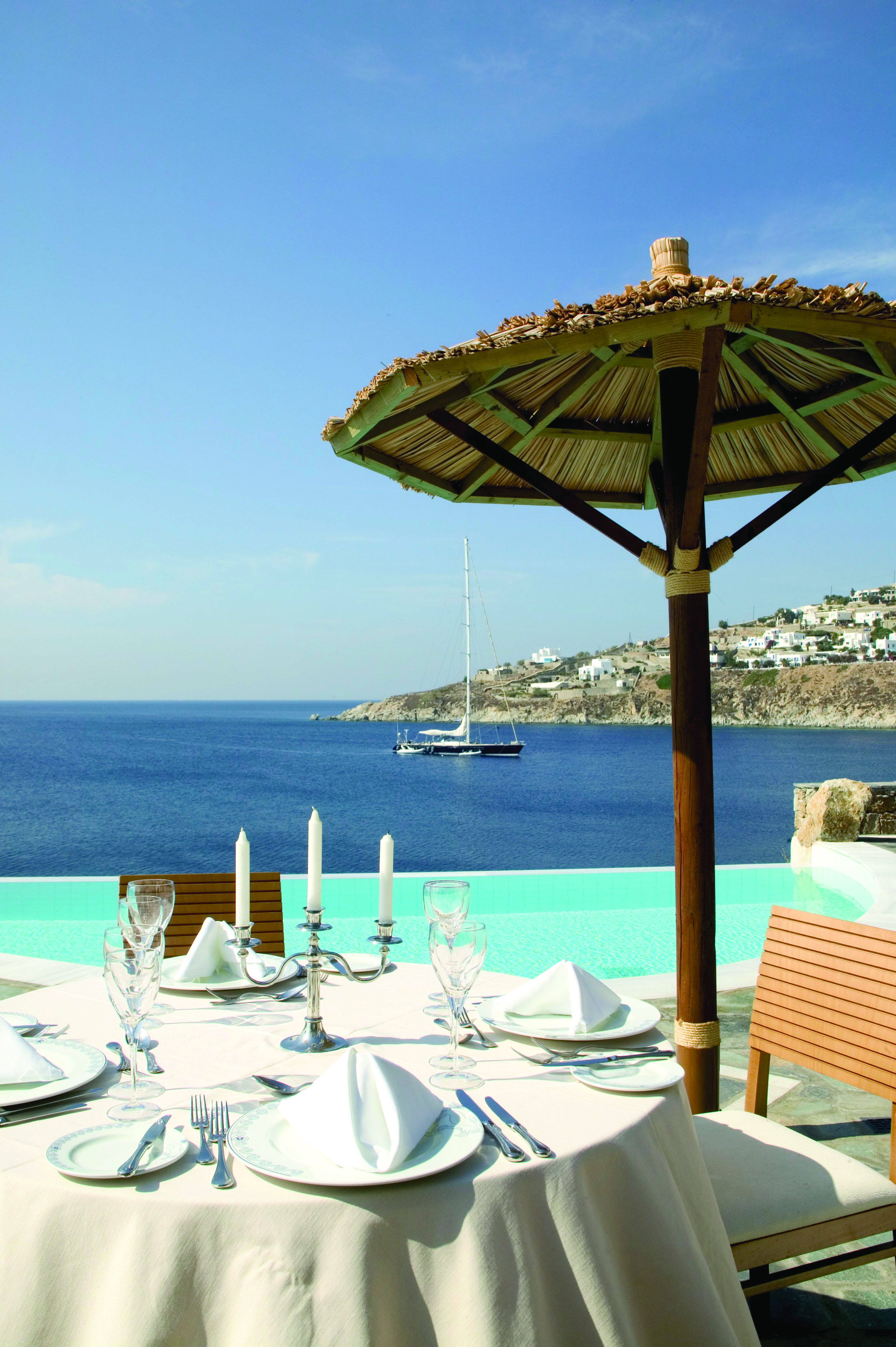 Petasos Beach Resort Greece dining pool outdoor dining area with candelabra overlooking pool and sea