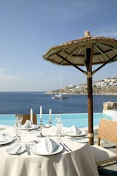 Petasos Beach Resort Greece dining pool outdoor dining area with candelabra overlooking pool and sea