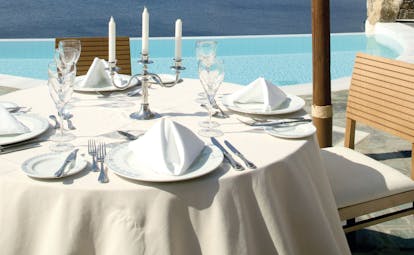 Petasos Beach Resort Greece dining pool outdoor dining area with candelabra overlooking pool and sea