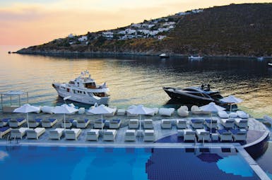Petasos Beach Resort Greece pool views  loungers and umbrellas sea and yachts