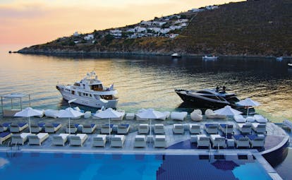 Petasos Beach Resort Greece pool views  loungers and umbrellas sea and yachts