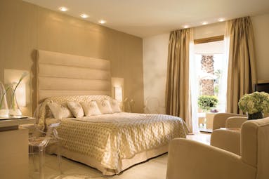 Porto Sani Greece family suite bedroom with two armchairs and view to terrace