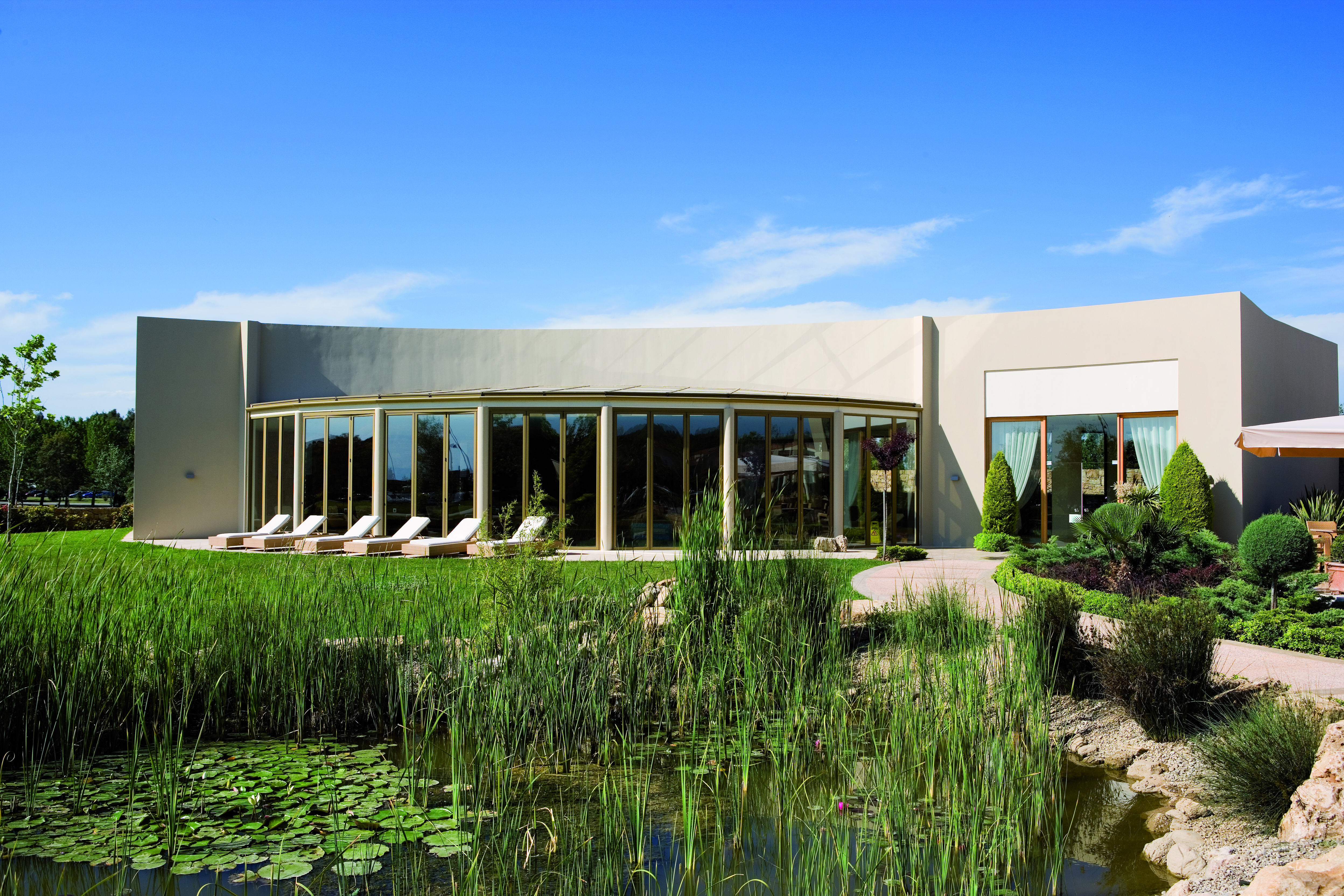 Porto Sani Greece gardens building with sun loungers gardens with pond