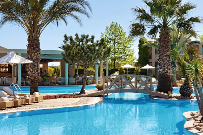 Porto Sani Greece outdoor pool with bridge and palm trees