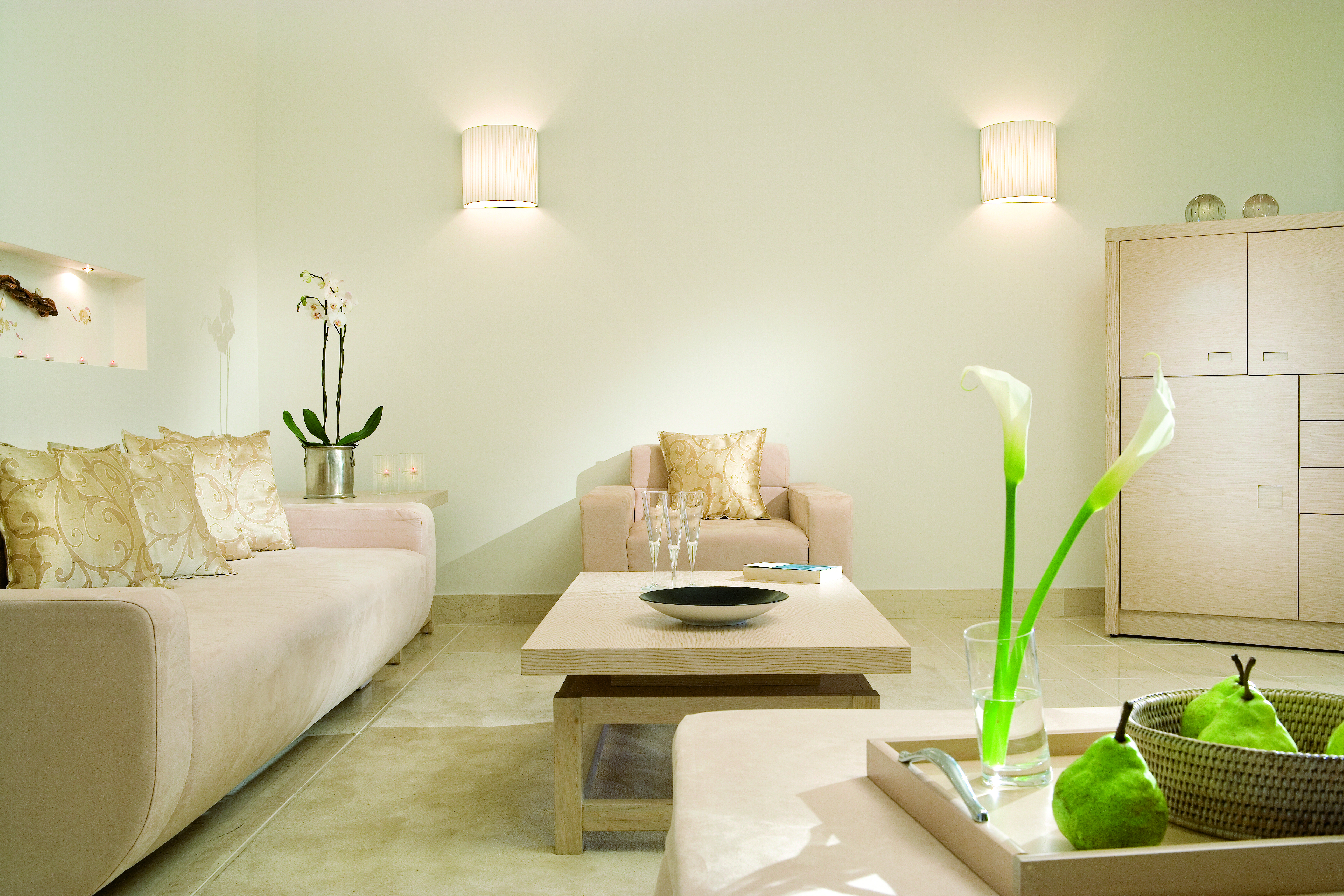 Porto Sani Greece suite sitting room with cream sofa and armchair and coffee table