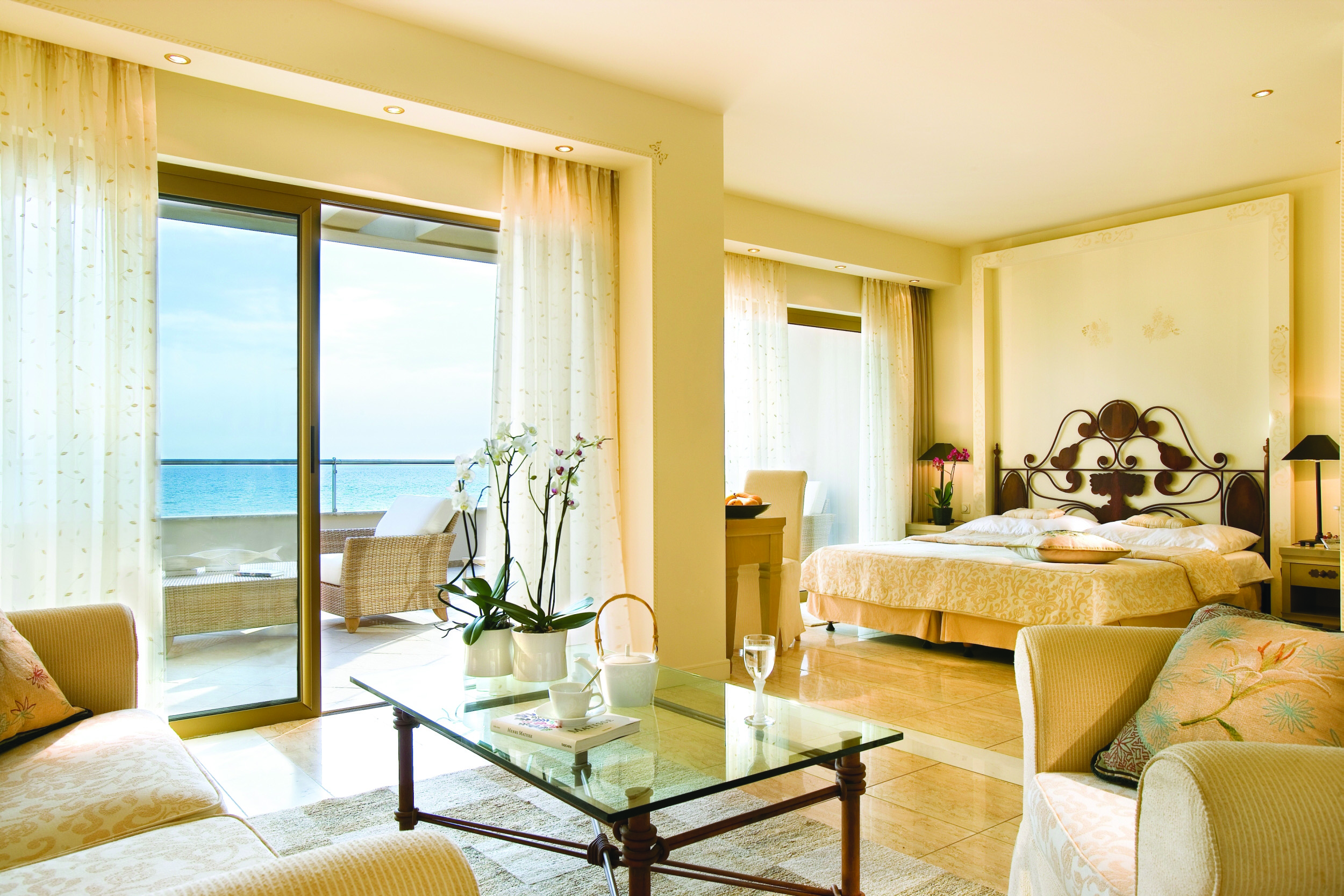 Sani Asterias Greece junior suite large bed sitting area balcony and sun loungers