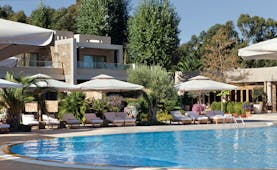 Sani Asterias Greece outdoor pool with sun loungers and umbrellas