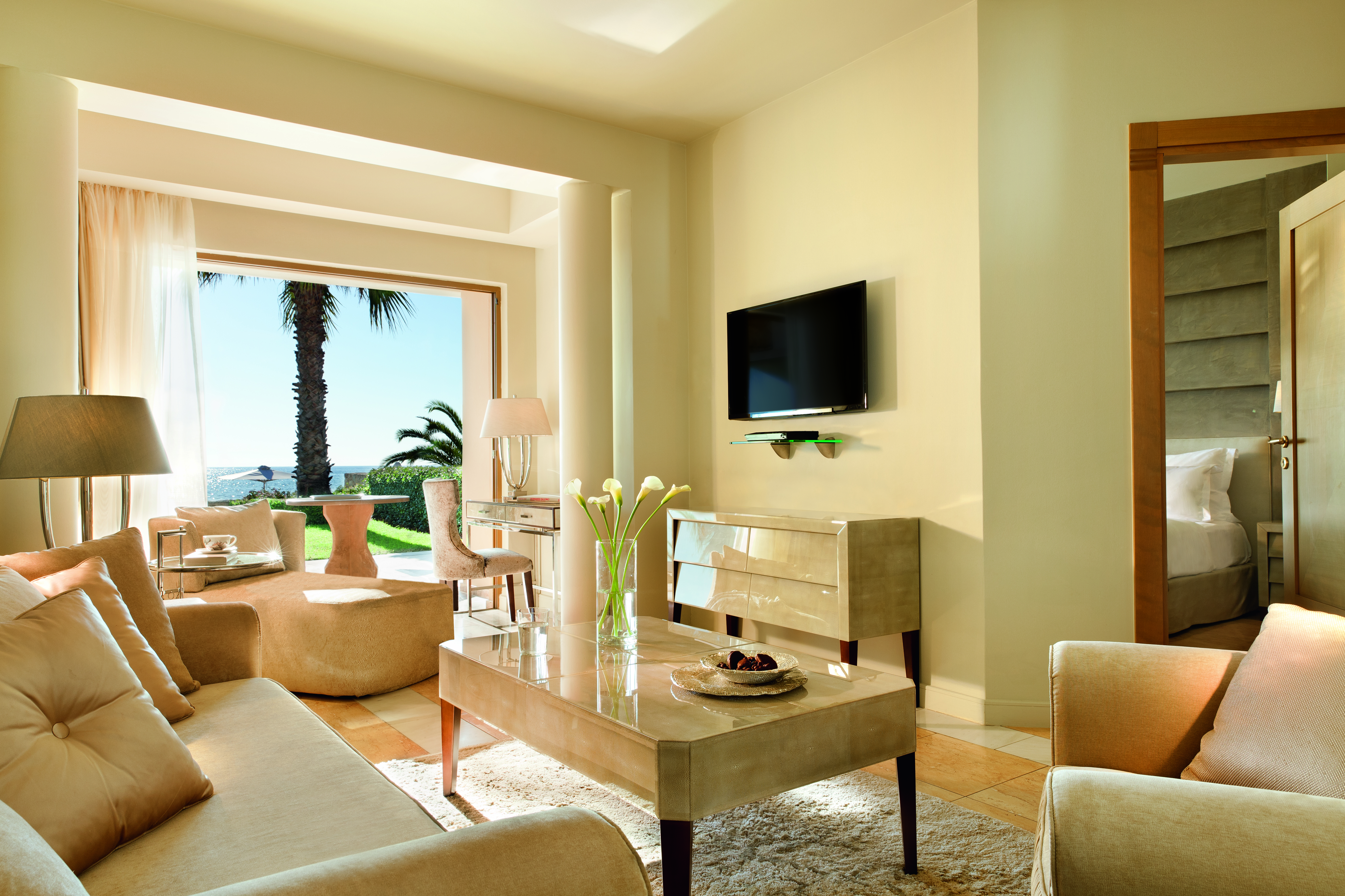 Sani Asterias Greece suite lounge with sofas view to bedroom and open view to terrace 