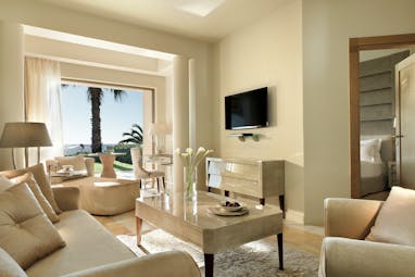 Sani Asterias Greece suite lounge with sofas view to bedroom and open view to terrace 