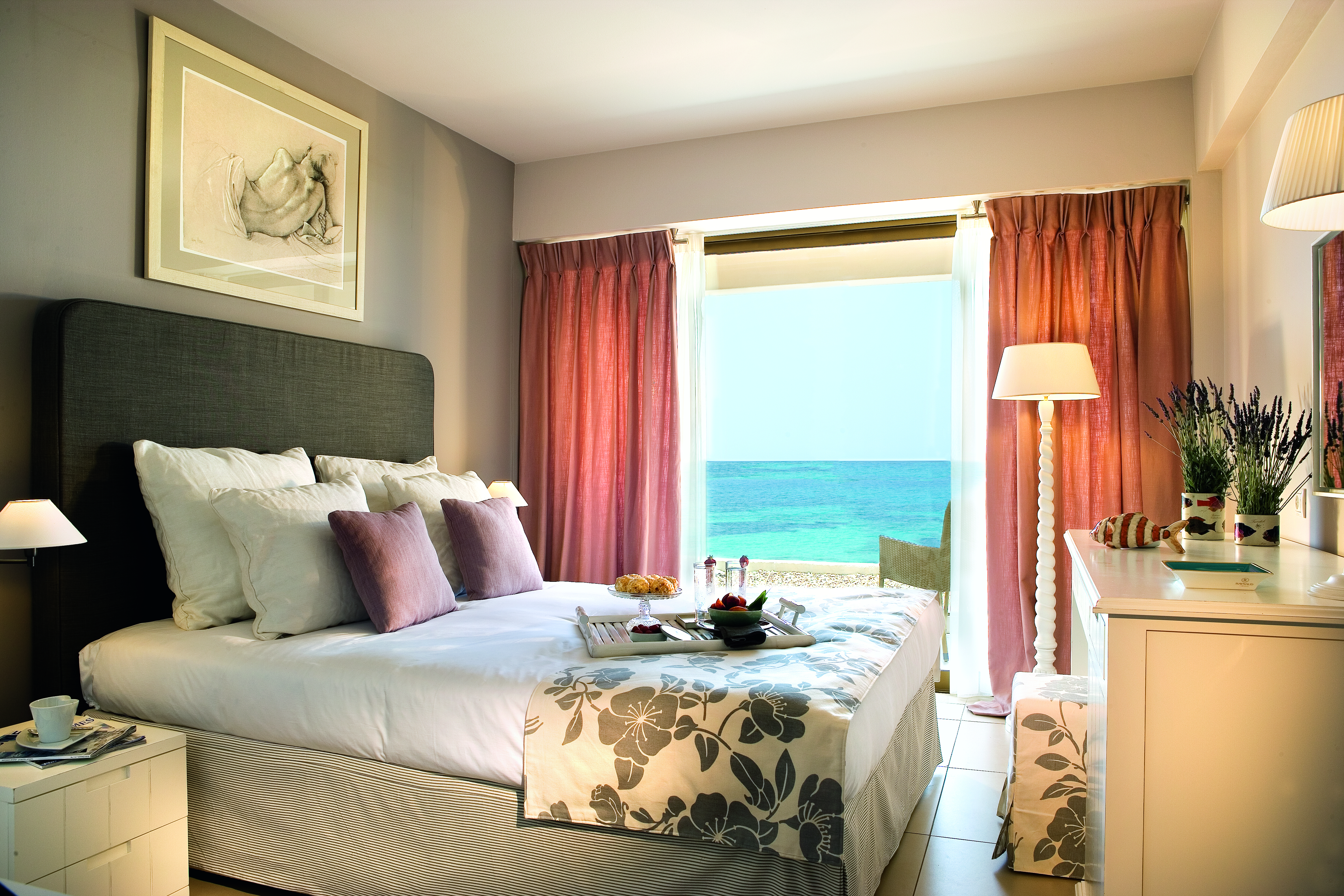 View of a Sani Beach family bedroom including a double bed and a large window a sea view