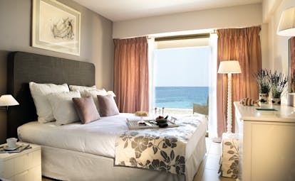 View of a Sani Beach family bedroom including a double bed and a large window a sea view