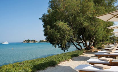 Sani Club Greece beachfront loungers umbrellas grass beach ocean