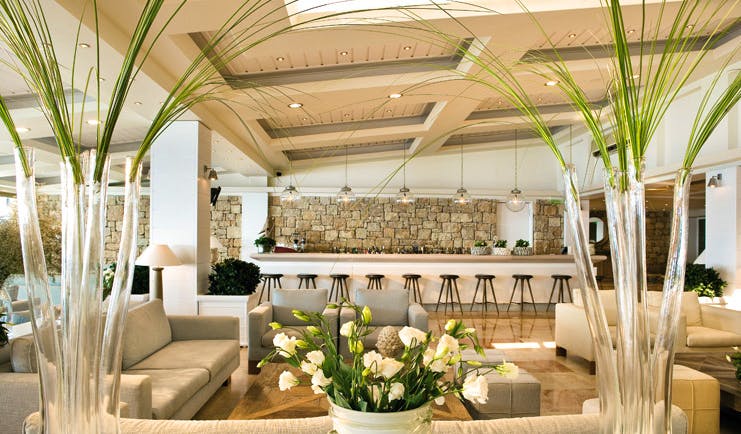 Sani Club Greece lobby minimalist decor floral arrangements bar area