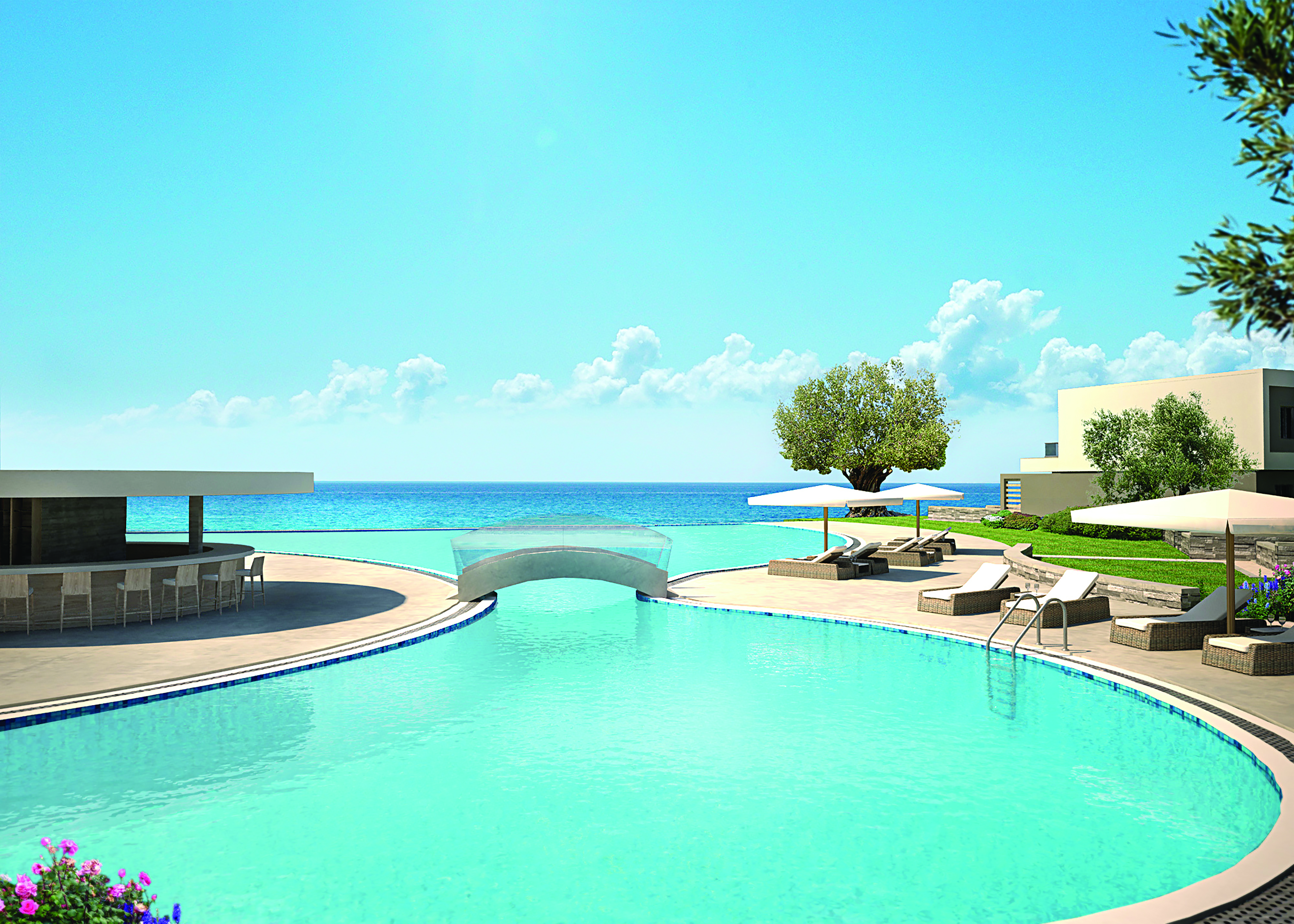Pool at the Sani Dunes hotel with sun beds around the outside, an arching bridge going over the middle of the pool and a sea view