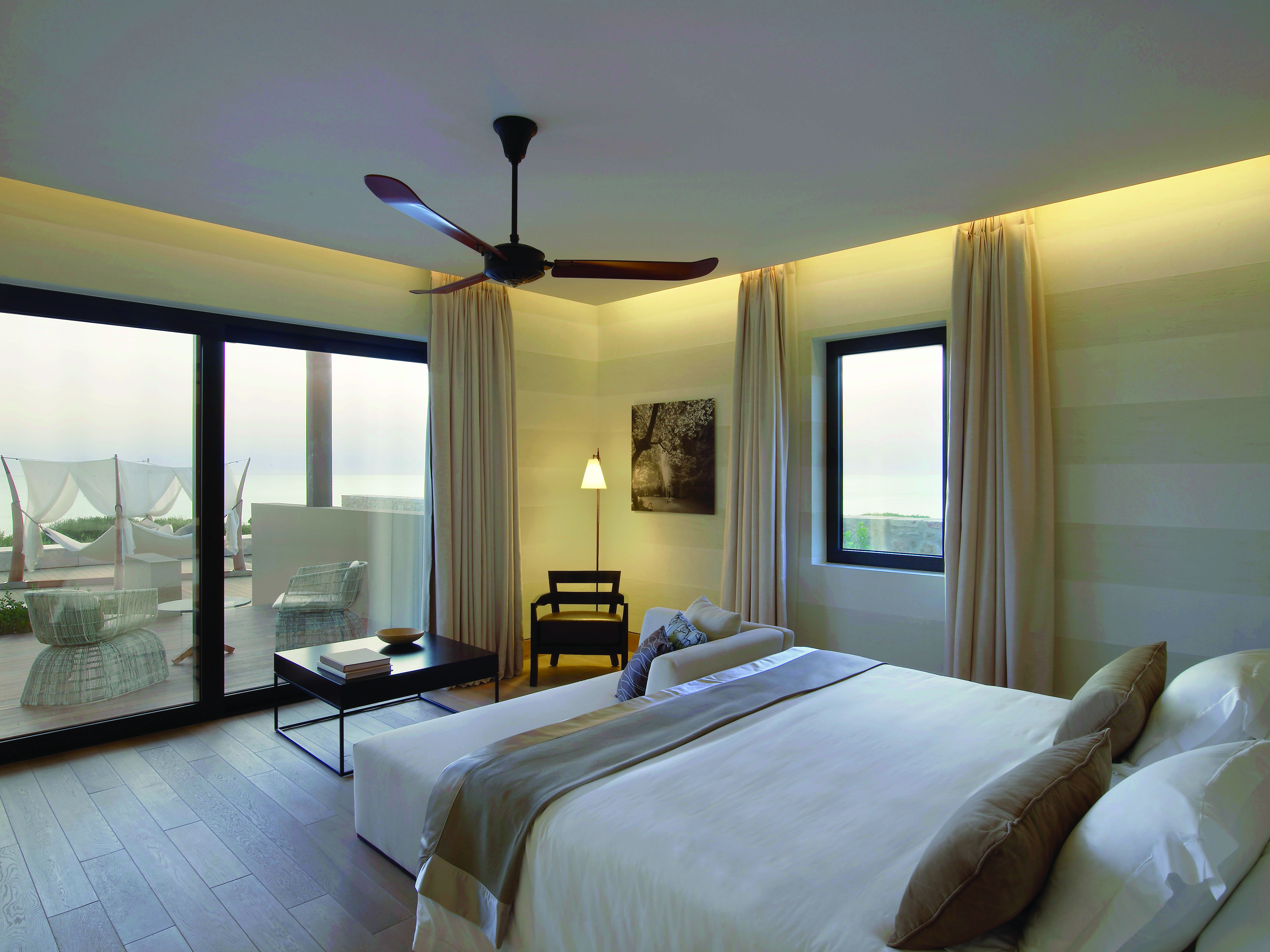 The Romanos Greece bedroom balcony with patio door to balcony and pool