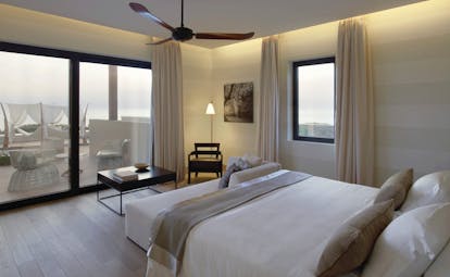 The Romanos Greece bedroom balcony with patio door to balcony and pool