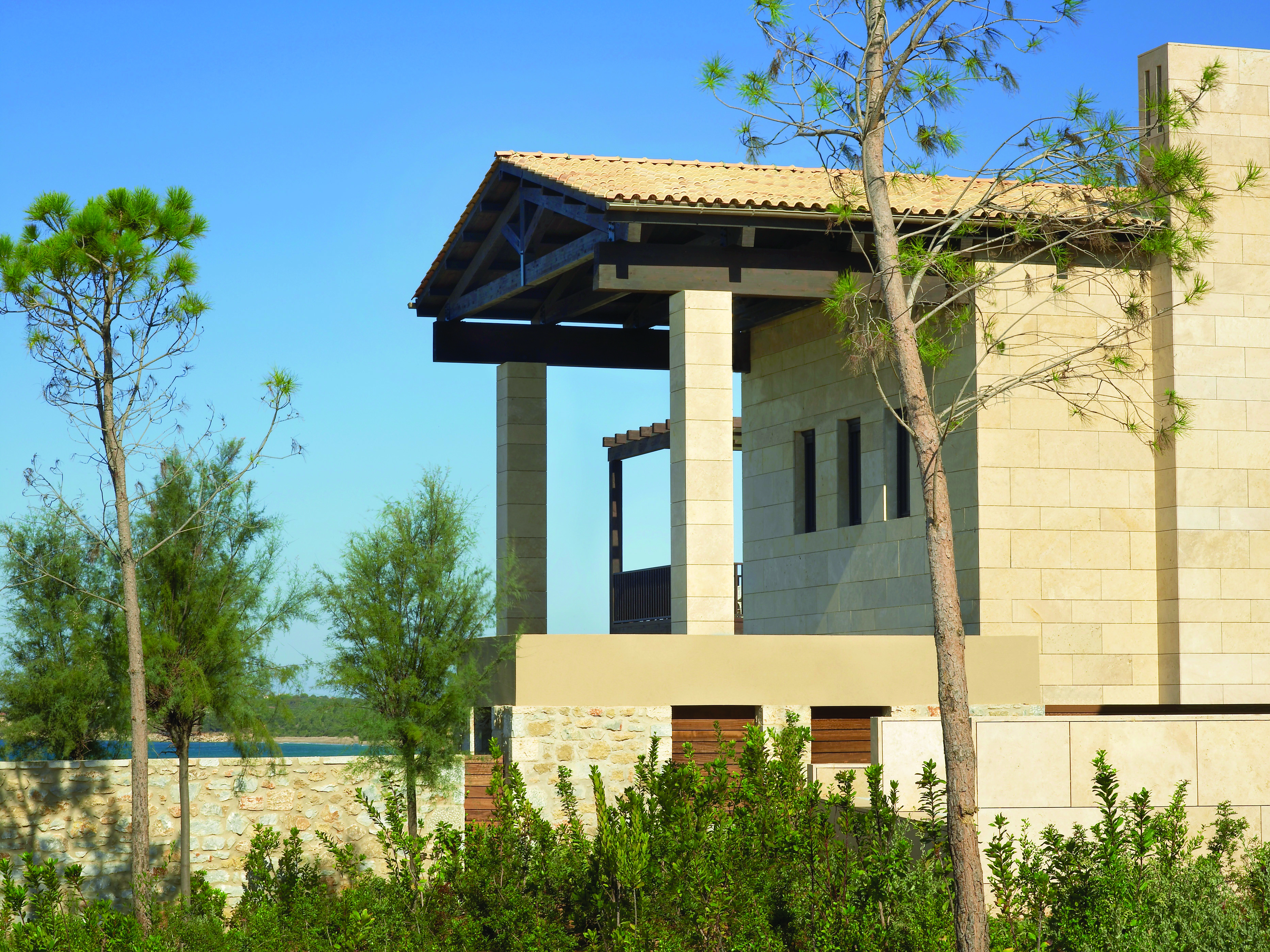 The Romanos Greece exterior stone building with trees 