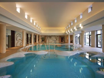 The Romanos Greece indoor pool with large windows 
