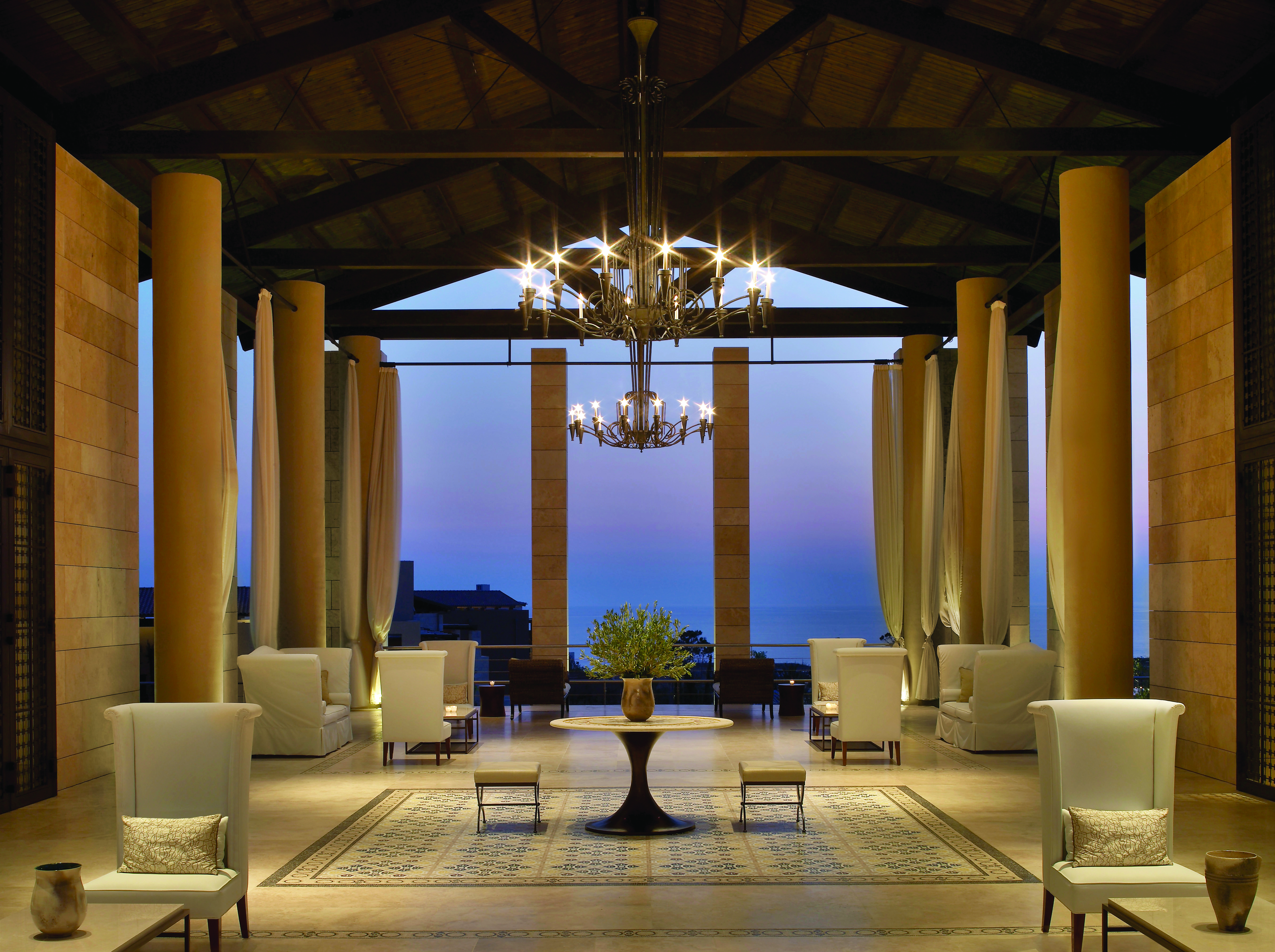 The Romanos Greece lobby evening open air covered lobby with seating area