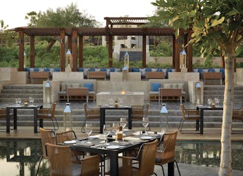 The Romanos Greece outdoor dining restaurant stepped seating area overlooking dining area 